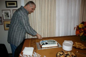 Michael Hannigan (yours truly) cuts the cake at a reception thrown by members of the Malakoff community. The event was organized to mark Hannigan leaving The Malakoff News. (LORETTA HUMBLE PHOTO)