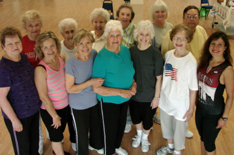 Friends and fellow members of the Fitness Plus class help Vera Jernigan (front and center) celebrate her 90th birthday. Jernigan exercises regularly and is an active volunteer. (COURTESY PHOTO)