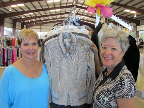 Janet Erwin and Linsey Garwacki, with the Ladies Boutique section, admire an evening jacket which is ready for some lucky customer to discover.