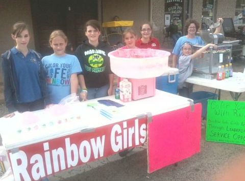 Pictured, from left, are Carrie Currey, Samantha Ramos, Kayla Rife, Emily Currey, Katie Schaefer, Dixie Rife, and Mrs. Tonya Currey (Mother Advisor) "man" the Gun Barrel City Rainbow Girls booth at the Ben Wheeler Hog Fest.