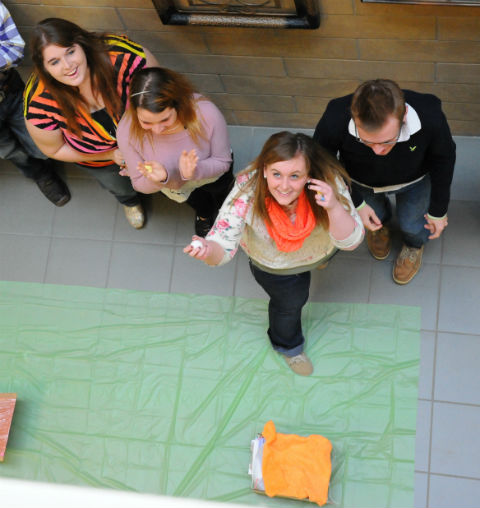 Cindy Mays of Elkhart High School shows off her unharmed egg after it dropped two stories into a device built by fellow teammates (from left) Laynnie Hogan of Slocum, Kali Oliver of Slocum and Lane Helms of Slocum during PTK's Leaders of Tomorrow Conference Friday.