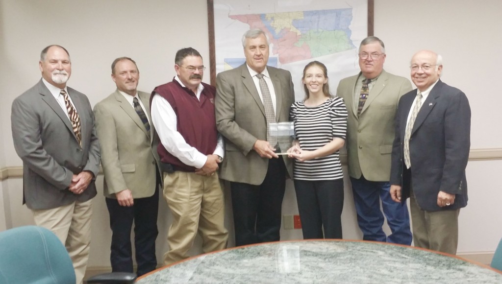 AgriLife Extension Agents Rick Hirsch and Lauren Tedford present Henderson County Commissioners' Court with a Building a Better Texas award in honor of the 100th anniversary of Cooperative Extension services across the country.