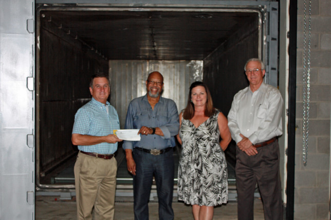 Steritec President and CEO Charles Jenkins receives a check from Athens Economic Development Corporation as part of an agreement between the two entities. Jenkins, who recently renovated and added equipment to his medical sterilization company, called the AEDC “absolutely vital for Athens.” Pictured (from left) are AEDC board member John Trent, Jenkins, AEDC board member Jeaneane Lilly and AEDC board member Cliff Barrett. (Courtesy photo)