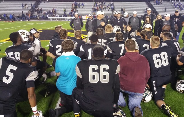 Coach Jamie Driskell talks to the team after Friday night's 41-14 win over Buna.
