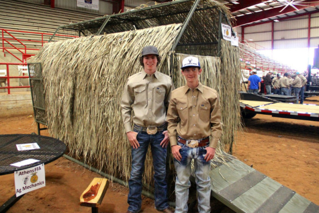 Athens High School students and Athens FFA members Justin Gatlin (left) and Drake Rummel stand in front of the duck blind they designed and built. It was one of many shop projects entered into the Henderson County Livestock Show this past week. The blind includes a ramp and skids to make it more portable. (Toni Garrard Clay/AISD)