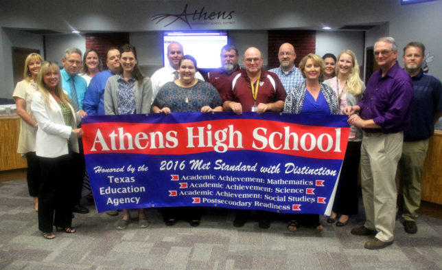 Athens High School is presented with a banner of achievement. The campus was honored for academic achievement in three areas: mathematics, science and social studies, as well as being honored for achievement in the category of postsecondary readiness. (Courtesy photo)