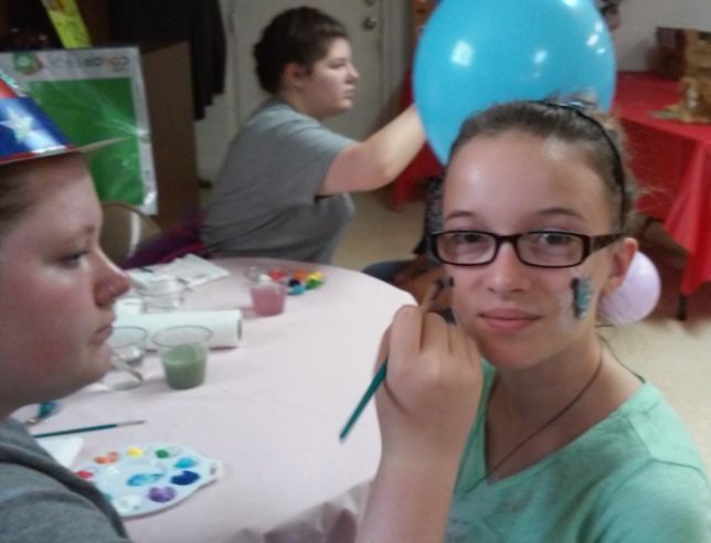 Michelle Sanderford, Past Worthy Advisor for Gun Barrel City #369 Rainbow Girls, painted faces at the Carnival Membership Party. Dixie Rife was getting a butterfly painted on her cheek. (Courtesy photo) 